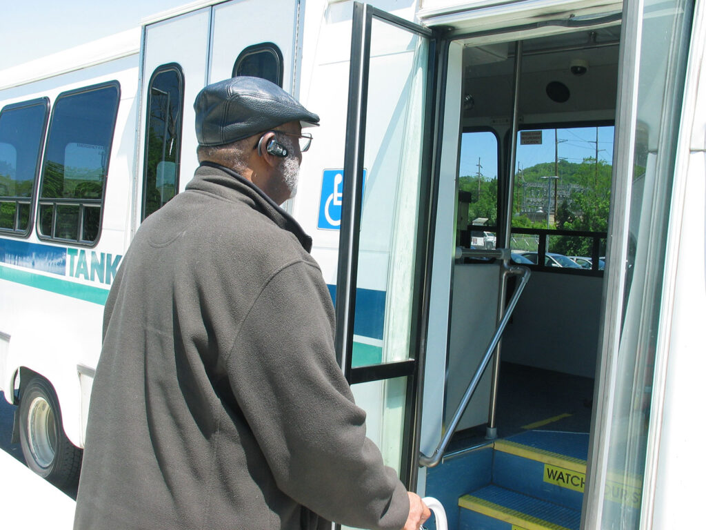 person with walker entering ramp bus